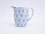 an image of a blue and white pitcher sitting on a white surface