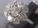 an image of a diamond cluster ring on a black stand