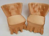 pair of orange chairs with ruffled seats and a white background