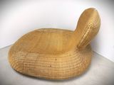 an image of a wicker lounge chair in a corner of a room