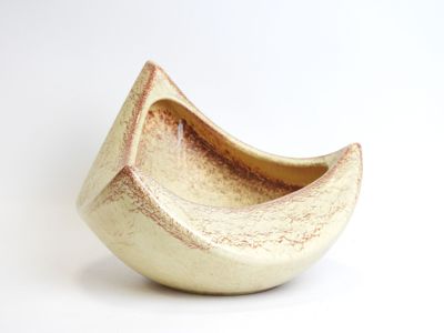 a small bowl that is sitting on a white surface