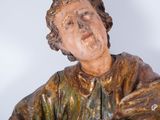 statue of a man holding a dog in his arms