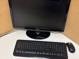 a computer monitor and keyboard sitting on a desk