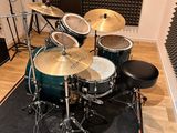 a drum set up in a recording studio with a microphone