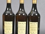 three bottles of wine sitting on top of a table next to each other