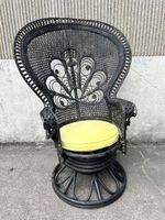 Fauteuil en rotin peacock noirci dit Emmanuelle reposant sur…