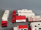 a lot of toy firetrucks and trucks on the table