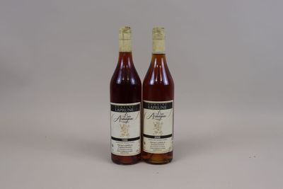 two bottles of wine sitting next to each other on a table