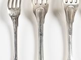 four forks that are sitting next to each other on a table