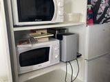a microwave and a refrigerator in a small room