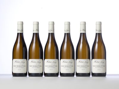 six bottles of white wine lined up in a row