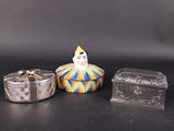 a small box with a clown face on it next to a small box with a clown face on it