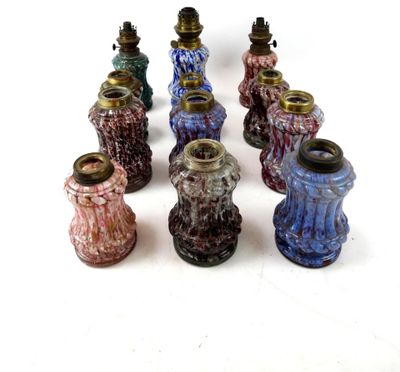 a lot of different colored vases on a white surface