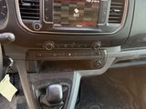 a dashboard of a car with a clock and a steering wheel