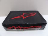 a box with a red alpinestar logo on it sitting on a table