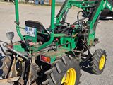a tractor that is parked in the dirt