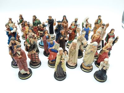 a lot of figurines that are sitting on a white surface