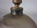a close up of a glass vase with a metal cap