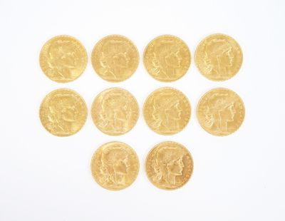 several gold coins arranged in the shape of a heart on a white surface