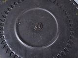a metal object with writing on it sitting on a table