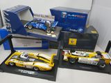 three model cars on display in a display case