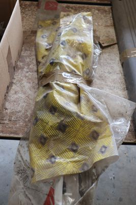 a bag of bananas sitting on the floor next to a box