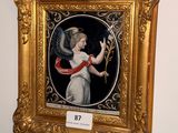 painting of an angel holding a flower in a gold frame