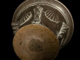 a close up of a metal object on a black background