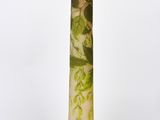 a glass vase with a green and white design on it