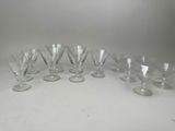 six wine glasses are lined up in a row on a table