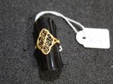 black and gold filigree ring with filigree filigree on it