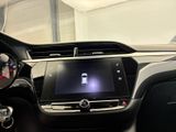 the interior of a car with a touch screen and steering wheel