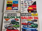 four magazines of different cars on display on a table