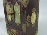 a small wooden box with gold decorations on it