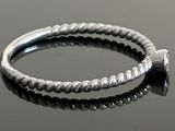 sterling silver ring with twisted rope design on a black surface