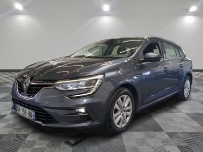 une voiture grise est garée dans une pièce au sol à carreaux