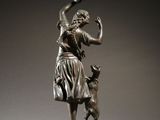 bronze statue of a woman and a dog on a pedestal