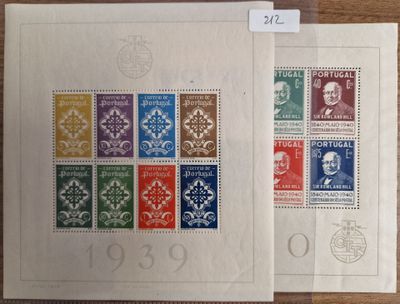 a couple of stamps sitting on top of a table next to each other