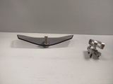 a silver object on a white table next to a pair of scissors