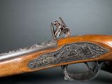 a close up of a rifle on a black background with a gray background