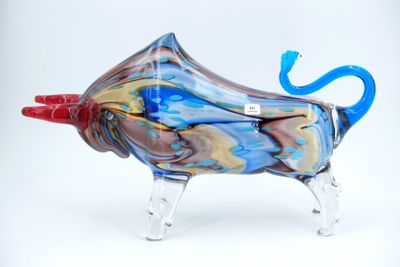 brightly colored glass sculpture of a cow with a red horn