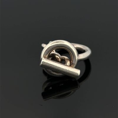 a close up of a silver ring on a black surface