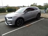 a picture of a silver suv parked in a parking lot