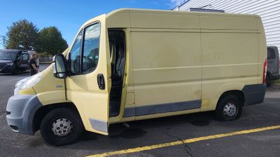 a yellow van that is parked in a parking lot