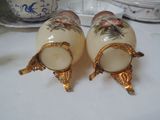 two salt and pepper shakers sitting on a table