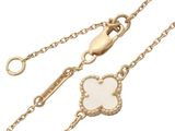 an image of a gold chain with a white flower on it