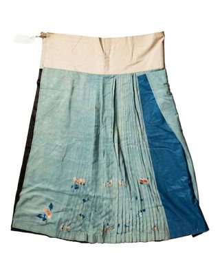 an image of a blue and white skirt with birds on it