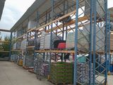 a large warehouse with a lot of pallets on the ground