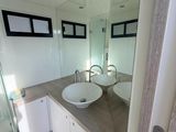 a bathroom with two sinks and a shower in it