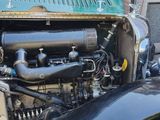 an old fashioned car with a large engine in it ' s trunk